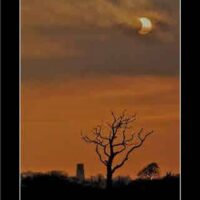 Eclipse at Sunrise' by Danny Hickling Super Sized A5 Vert Blk Border Art Print